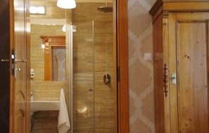 A bathroom with a glass-enclosed shower, a wooden door, and a visible towel rack. - Villa la Val (Kamienna Gora)