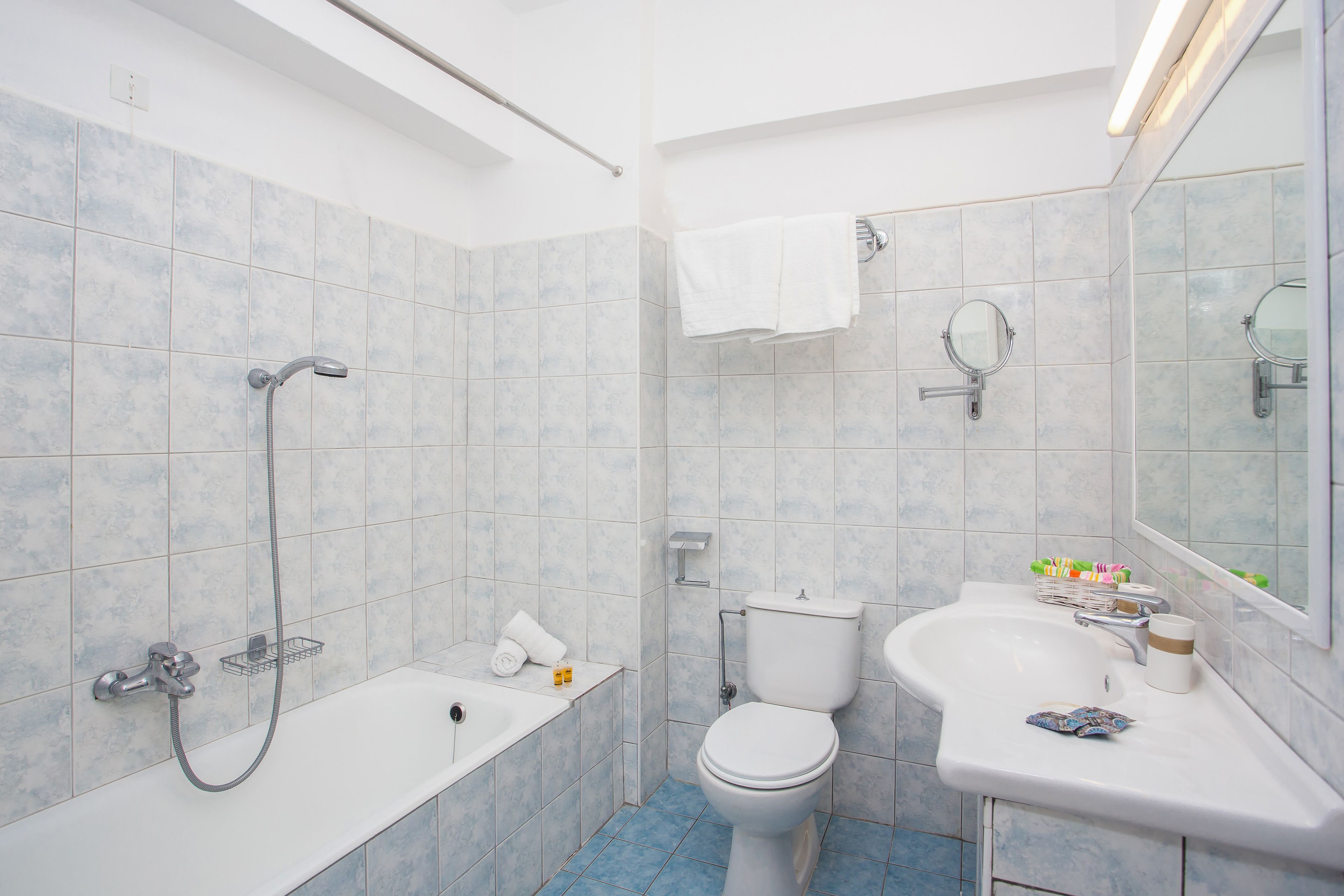 bathtub, deep-soaking bathtub, hair dryer, towels