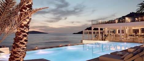 Seasonal outdoor pool, open 10:00 AM to 6:00 PM, pool umbrellas