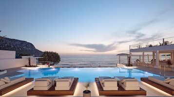 Seasonal outdoor pool, open 10:00 AM to 6:00 PM, pool umbrellas