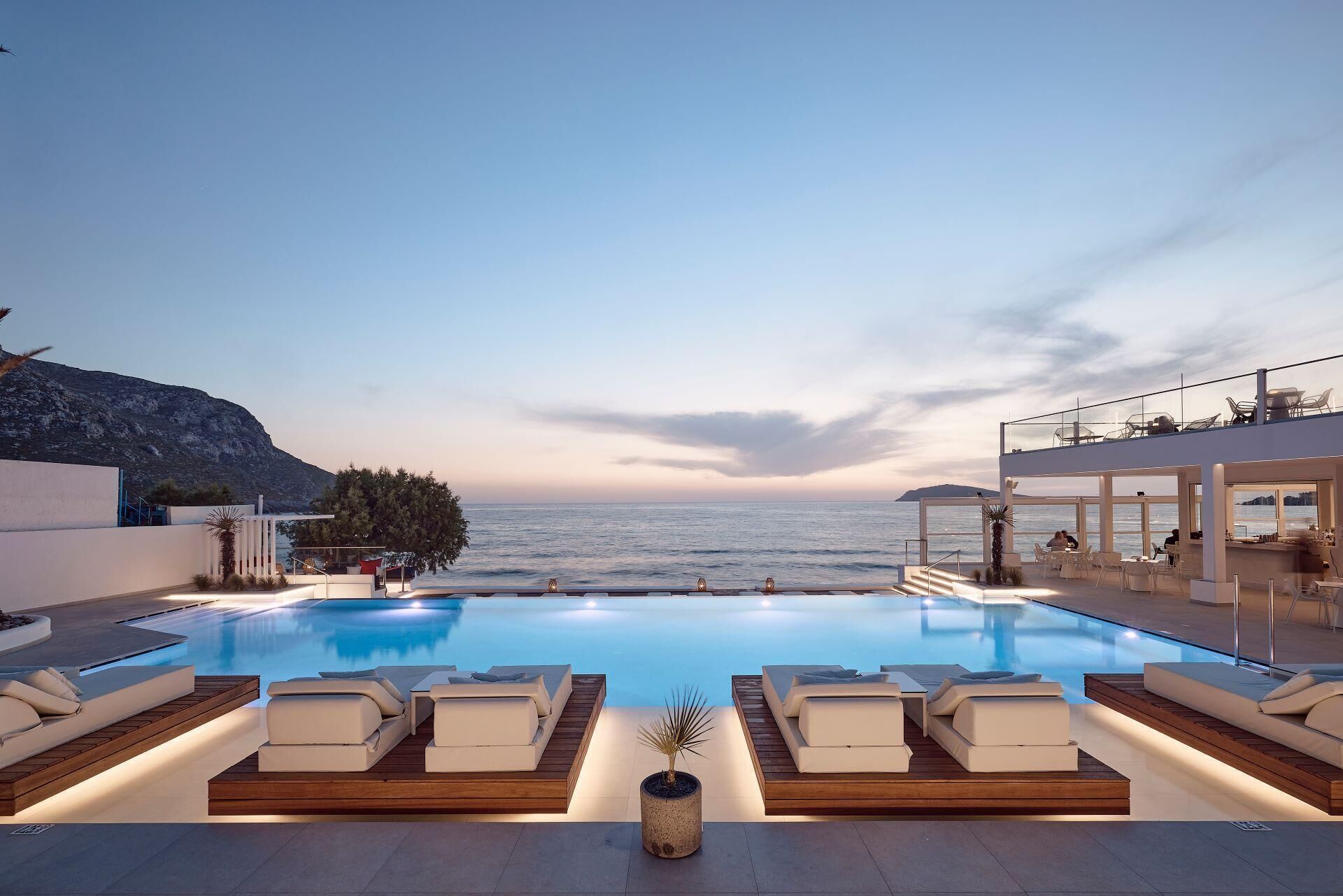 Seasonal outdoor pool, open 10:00 AM to 6:00 PM, pool umbrellas