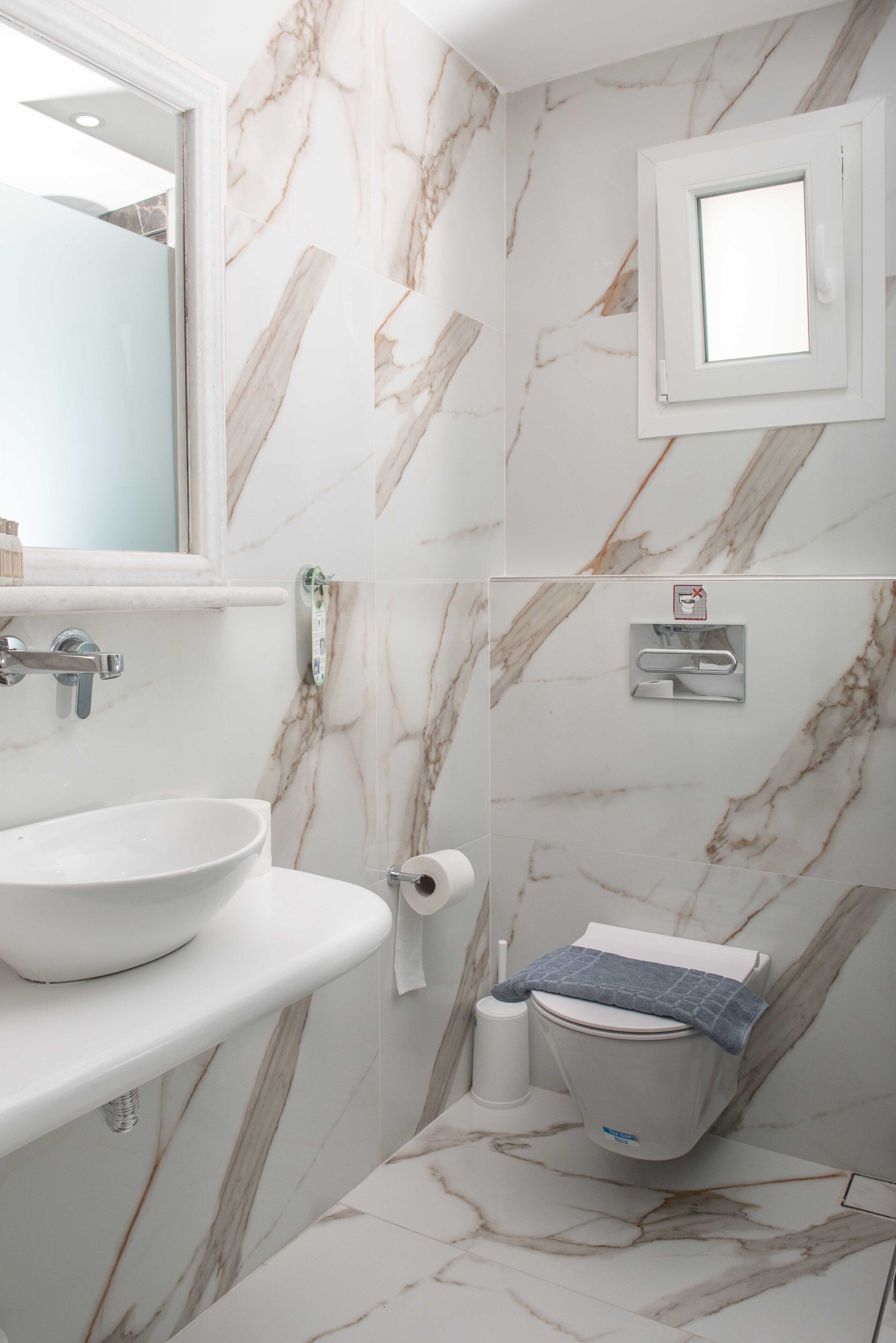 shower, hair dryer, slippers, towels