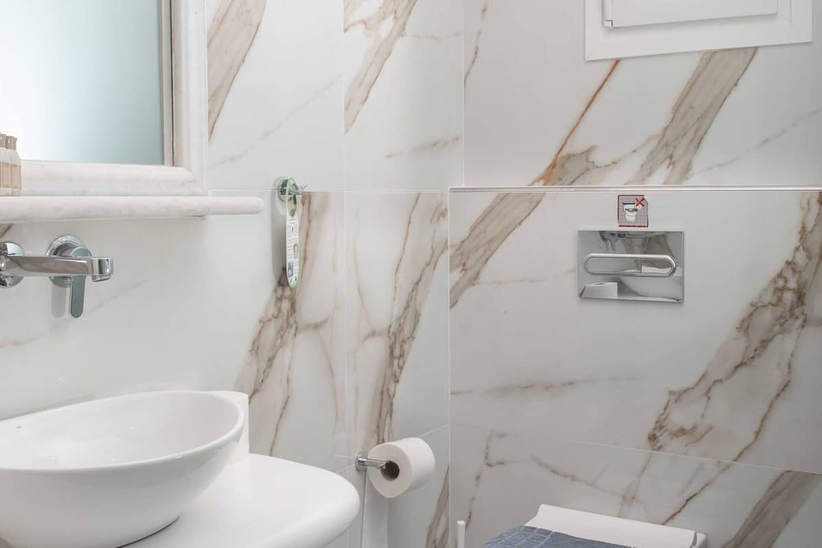 shower, hair dryer, slippers, towels