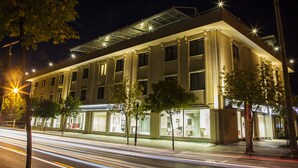 A modern hotel with a flat roof, large windows, and a well-lit facade. - Gosterisli Hotel (Düzce)