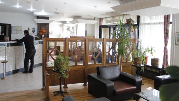 A hotel lobby with a reception desk, seating area, and large windows. - Saban Acikgoz Hotel (Edirne)