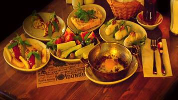 A table set with various dishes including bread, salads, and a bowl of eggs.