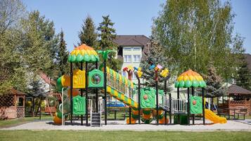 A playground with multiple play structures including slides and climbing areas.