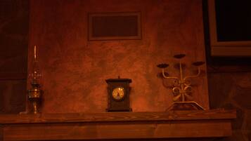 A fireplace with a clock and candelabra on the mantel.