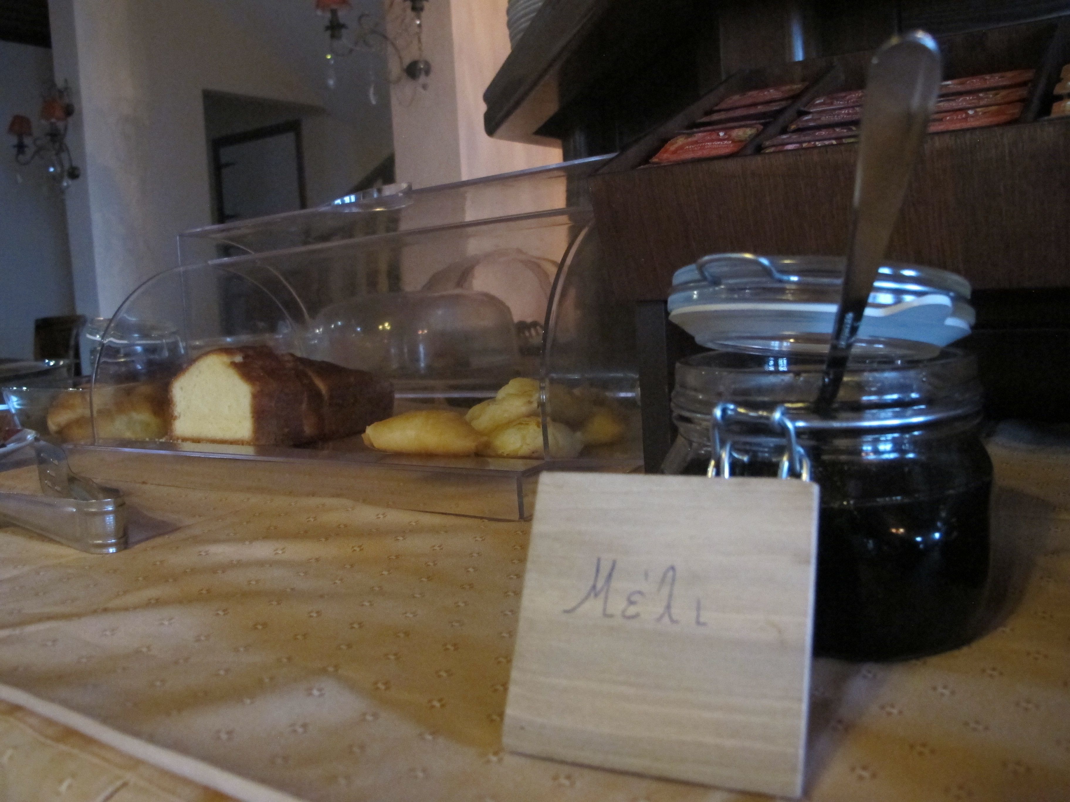 A breakfast counter with a variety of pastries and a jar of jam.