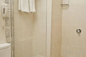 A bathroom with a shower, a toilet, and a towel rack. - Asmali Hotel (Istanbul)