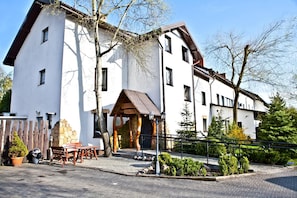 A two-story building with a stone facade and a wooden porch.