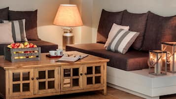 A cozy living room with a sofa, a wooden coffee table with storage, a lamp, and decorative lanterns.