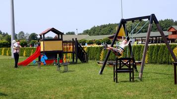 Kids can play on the swing set and slide in this outdoor playground area.