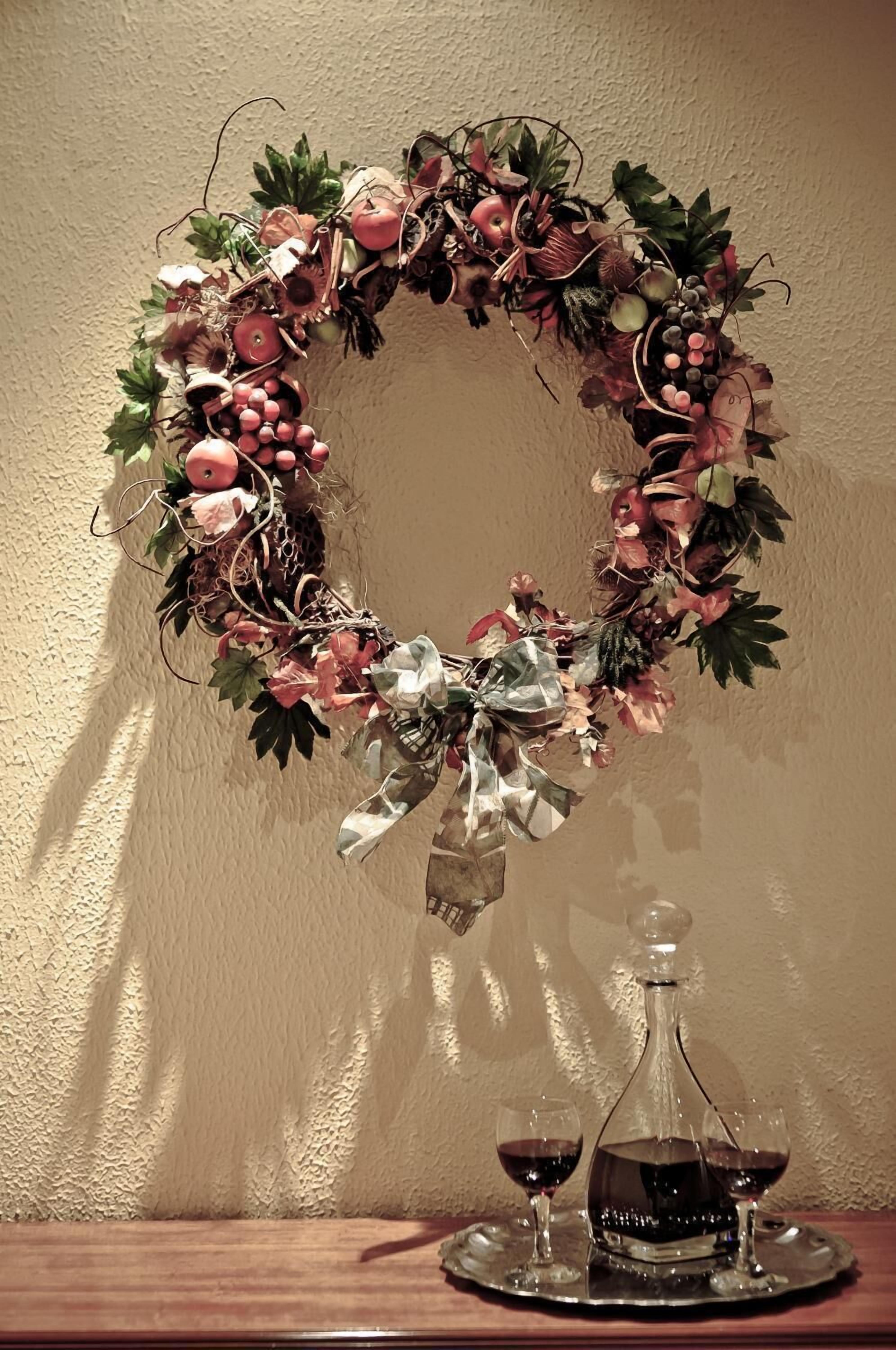 A wreath with a bow on a wall.