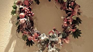 A wreath with a bow on a wall.