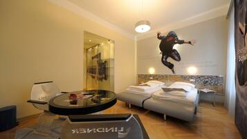 Relax in a stylish room with a round table, comfortable chair, and a large mirror.