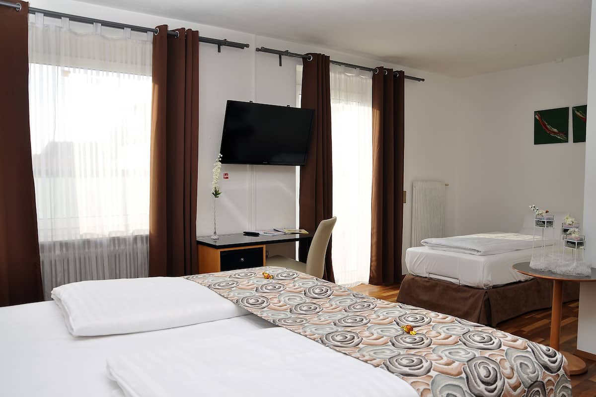 Premium bedding, desk, laptop workspace, blackout drapes