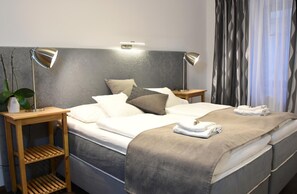 Premium bedding, desk, laptop workspace, blackout curtains