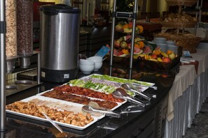 A buffet with various food items, including meats, salads, and fruits. - Hotel Silver (Hajduszoboszlo)