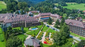 Un complejo hotelero con varias construcciones, piscina y parque infantil.
