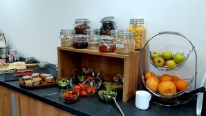 A buffet setup with various food items and condiments. - Vén Diófa De Lux Panzió (Szeged)