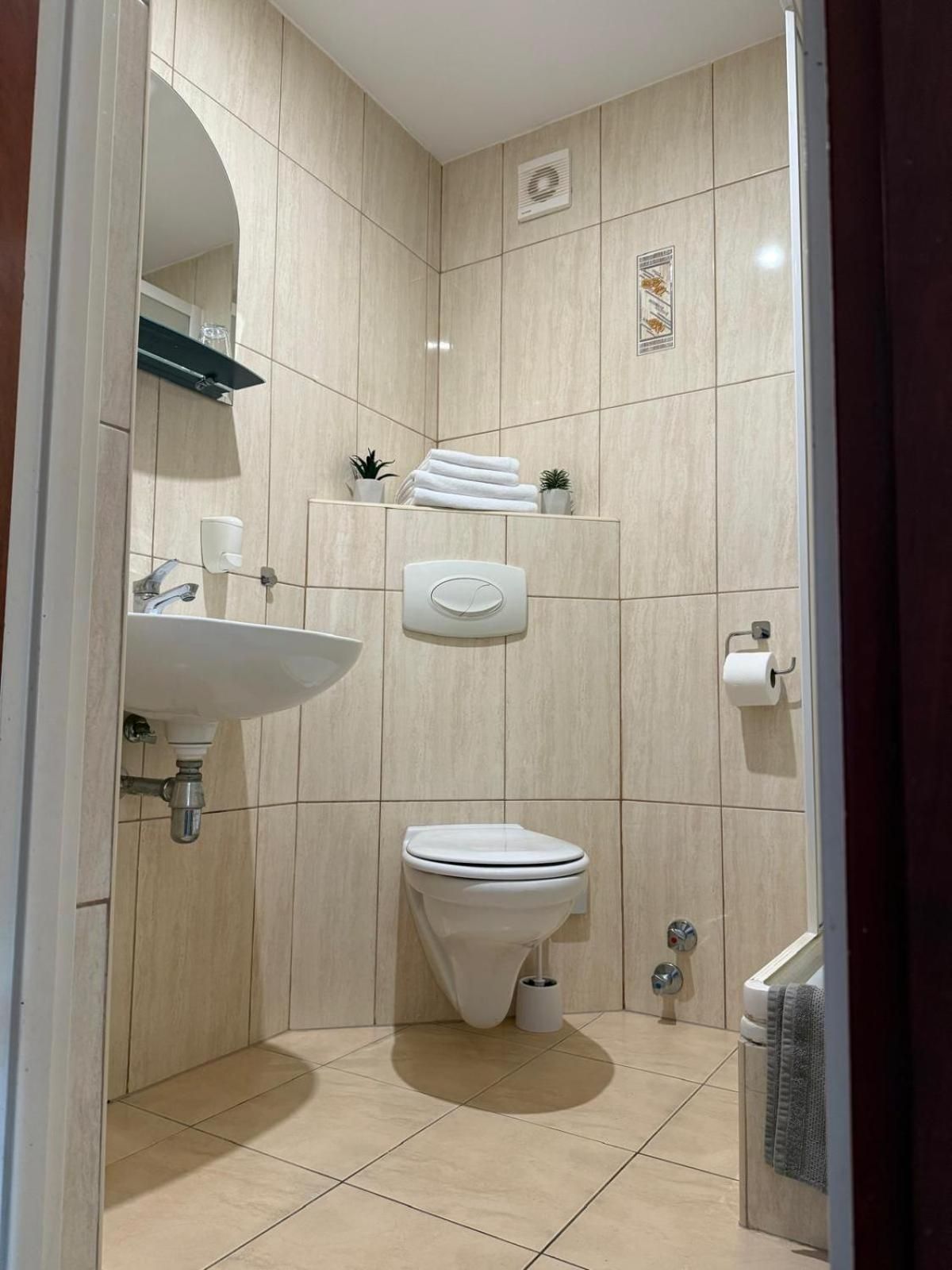 A modern bathroom with a toilet, sink, and shower area.