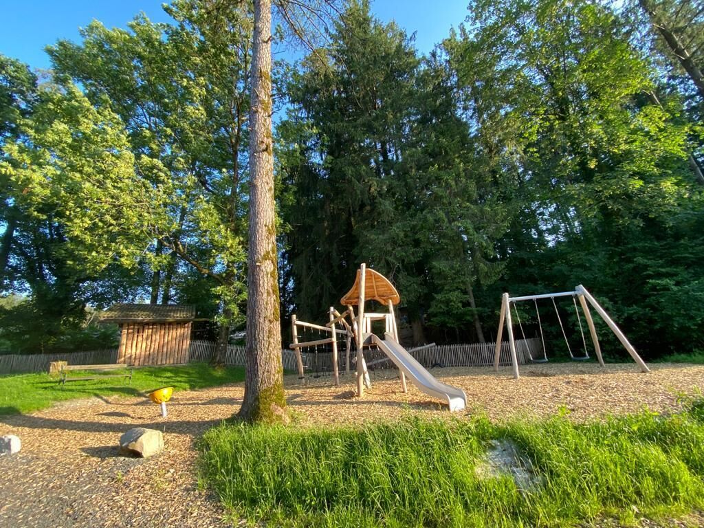 A playground with a slide, swings, and a climbing structure.