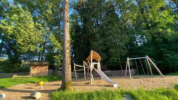 A playground with a slide, swings, and a climbing structure.