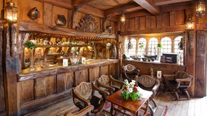 A rustic bar area with wooden furniture, a bar counter, and vintage decor. - Belleek Castle (Ballina)