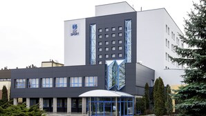 A modern building with a sign reading "Sport".