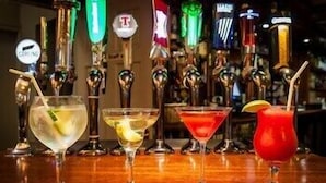 A bar with multiple taps and three different cocktails. - Lake Of Shadows (Buncrana)