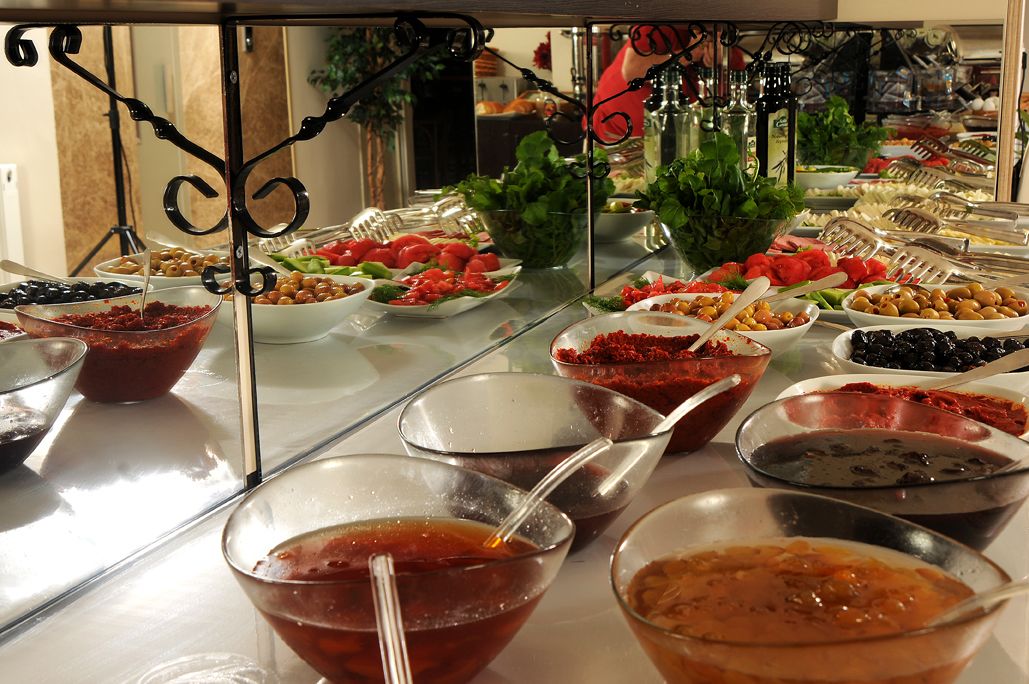 A buffet with various food items and condiments.