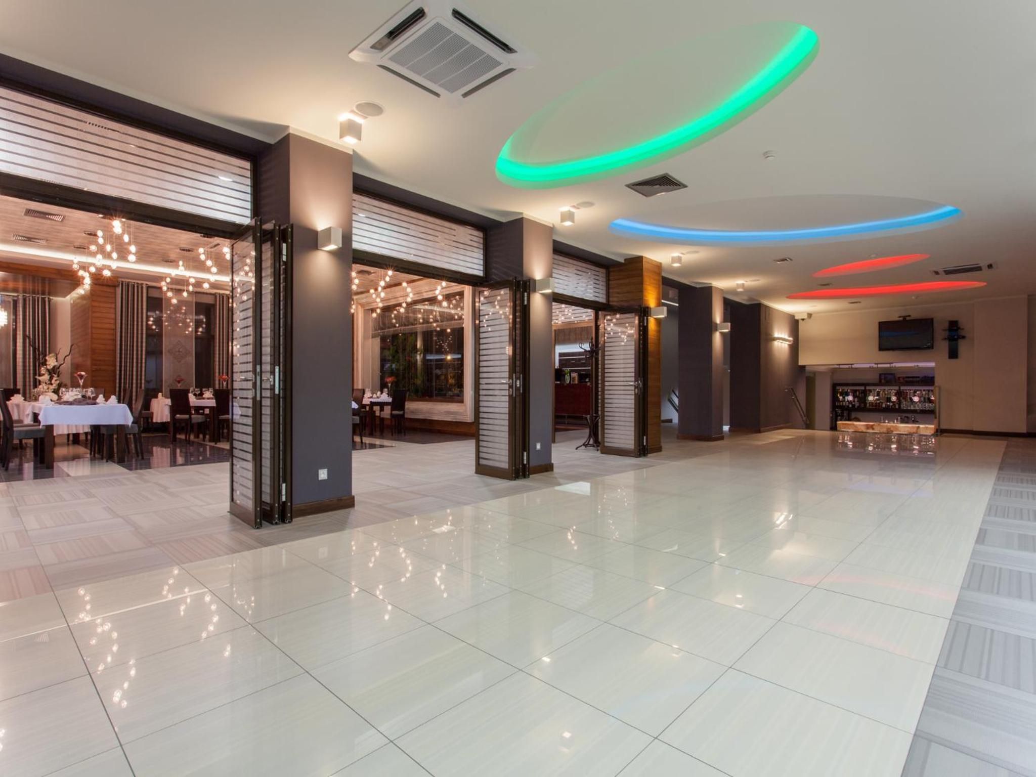 A spacious lobby with a modern design, featuring a bar area and seating arrangements.