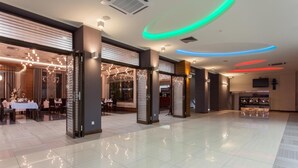 A spacious lobby with a modern design, featuring a bar area and seating arrangements.