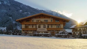 A multi-story hotel with a wooden facade, balconies, and a sign reading "Landhaus Gasser". - Landhaus Gasser (Mayrhofen)