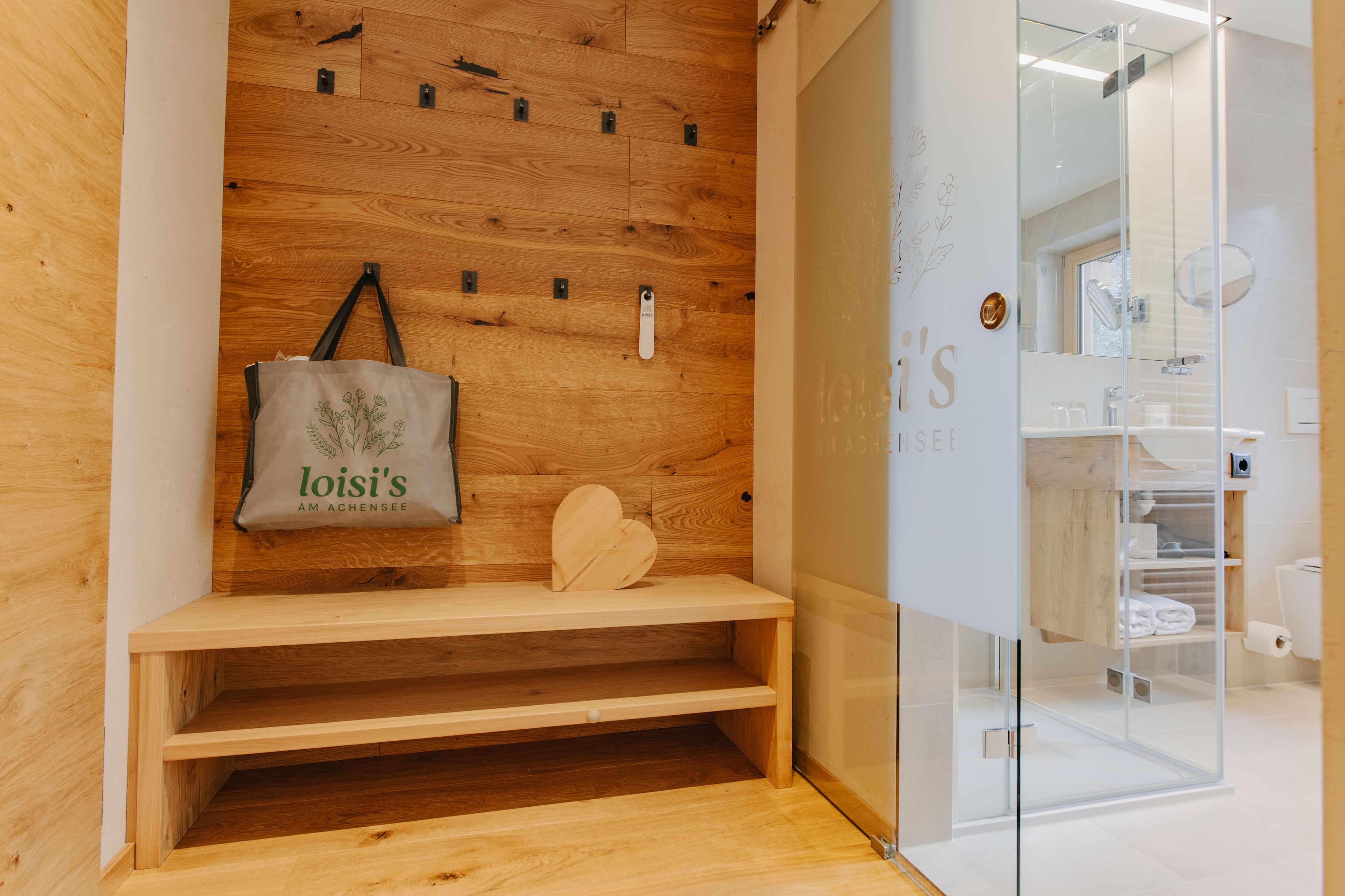 A wooden wall with a hanging bag and a heart-shaped object.