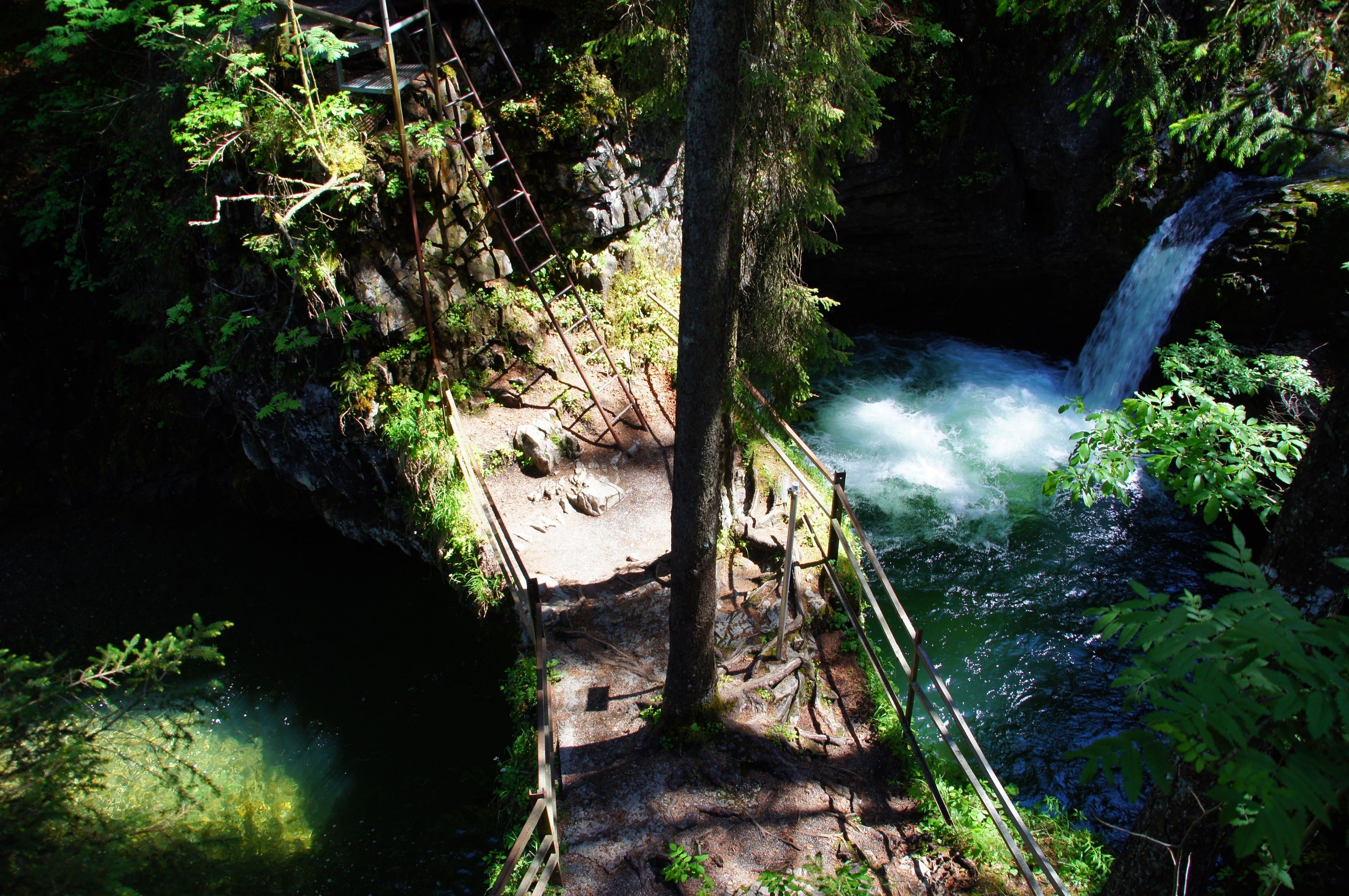 A natural waterfall surrounded by dense forest.
