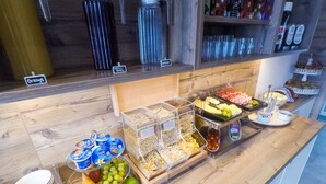 A breakfast buffet with various food items and condiments. - Collina Hotel Garni (Nauders)