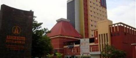 A hotel with a prominent red building and a tall structure with a white facade.