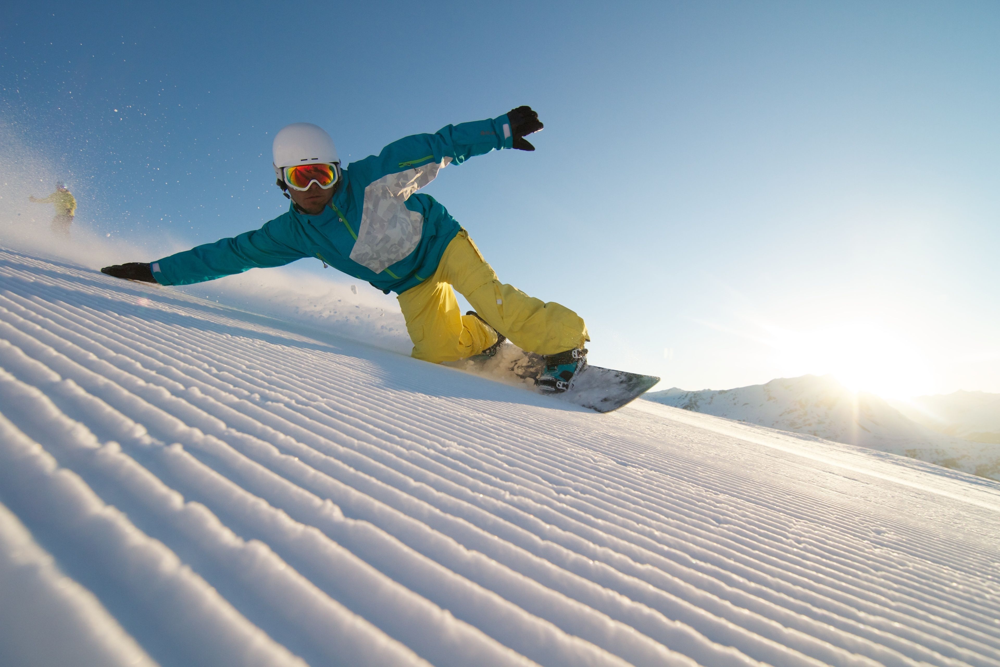 A snowboarder in motion on a snowy slope.