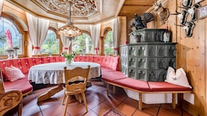 Une pièce avec une table ronde, des bancs et un meuble décoratif.