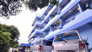 A multi-story building with blue exterior walls and balconies.