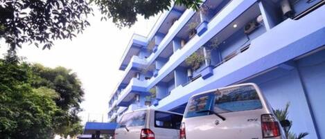 A multi-story building with blue exterior walls and balconies.