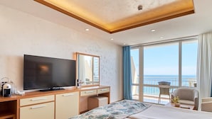 A hotel room with a bed, a TV, a desk, and a view of the sea. - Bilyana Beach (Nesebar)