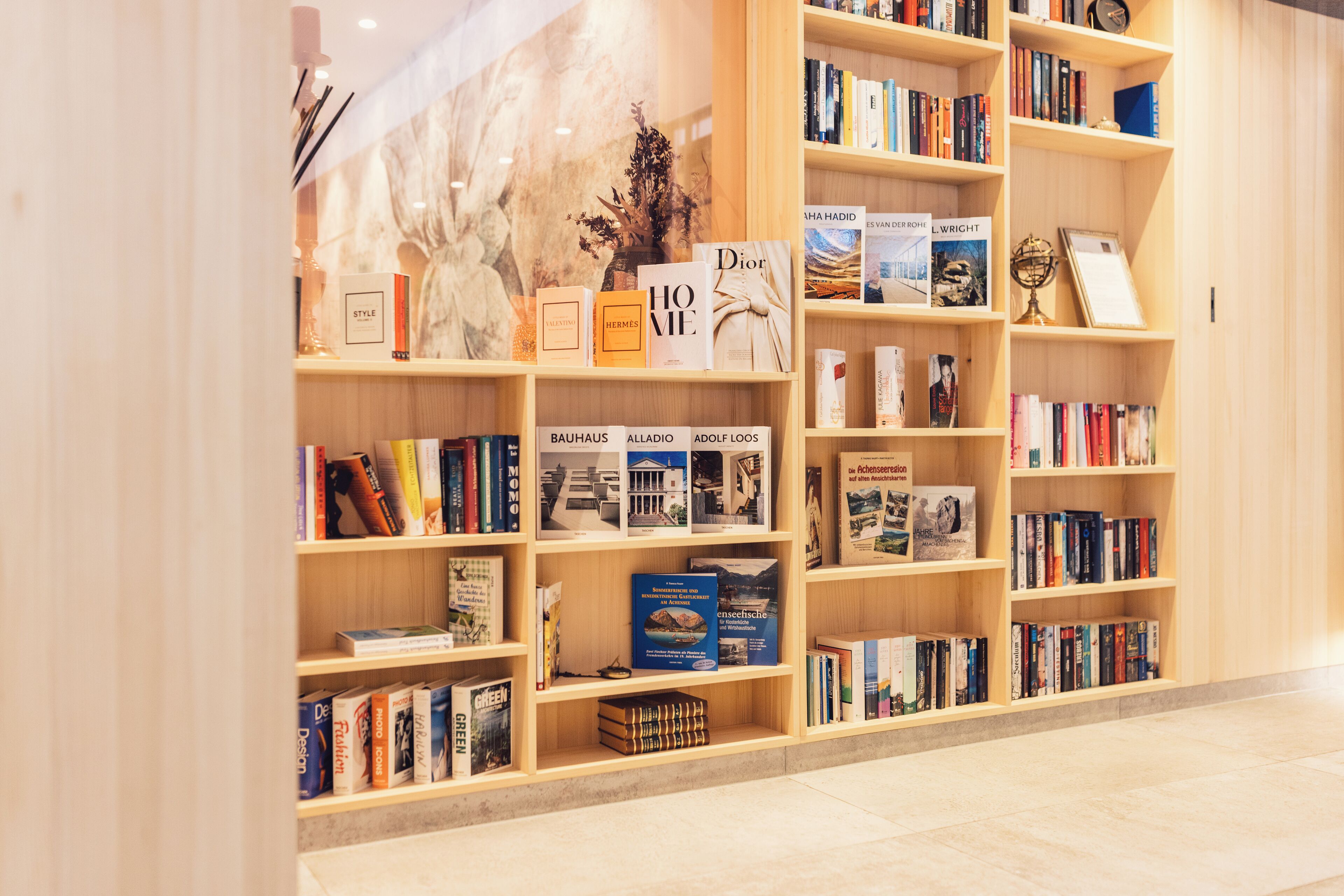 A bookstore with multiple shelves filled with books and a few decorative items.