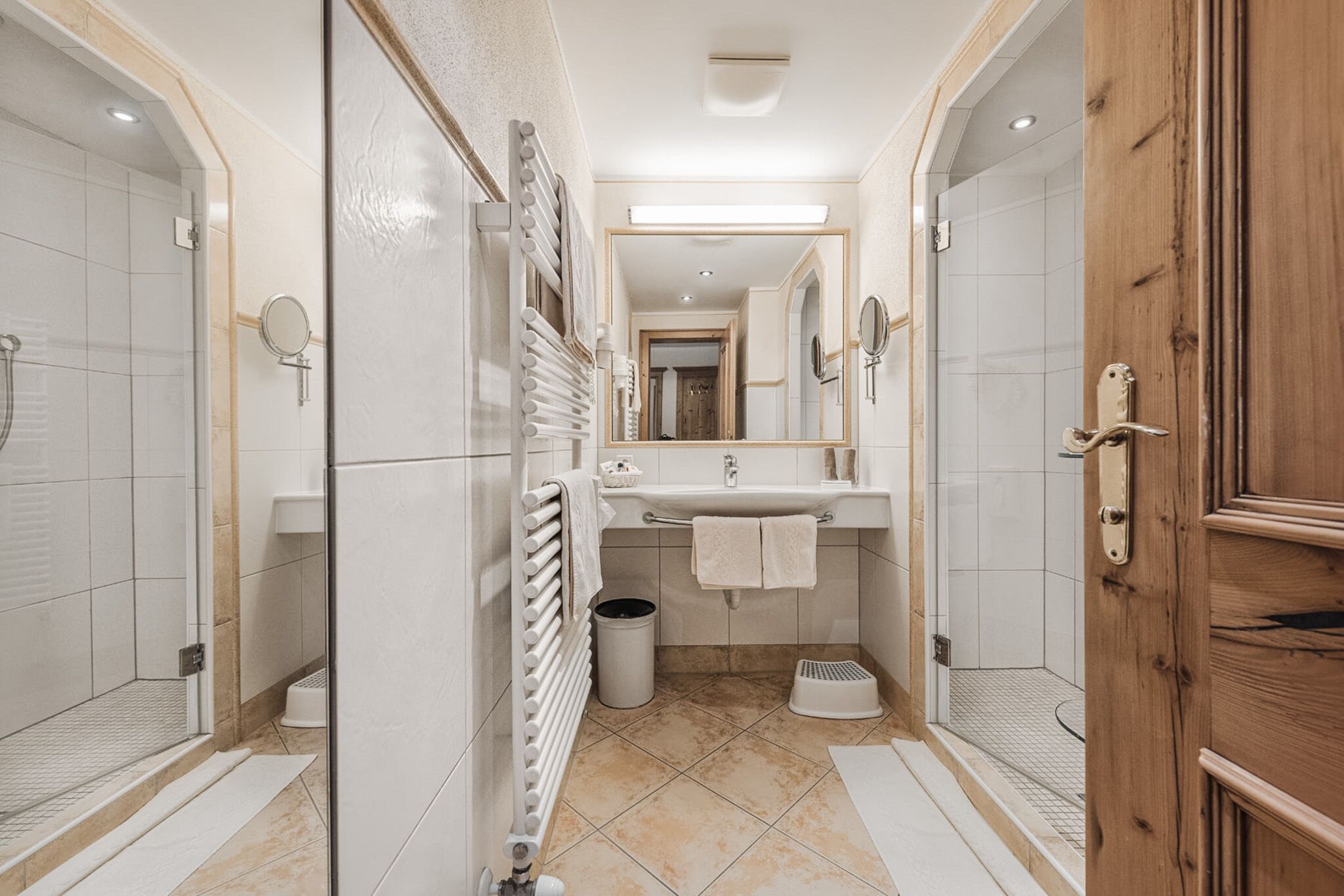 A modern bathroom with a shower, sink, and mirror.