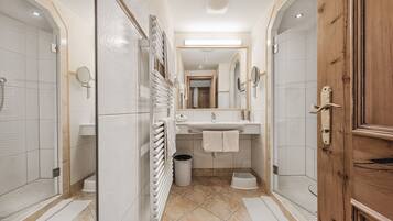 A modern bathroom with a shower, sink, and mirror.