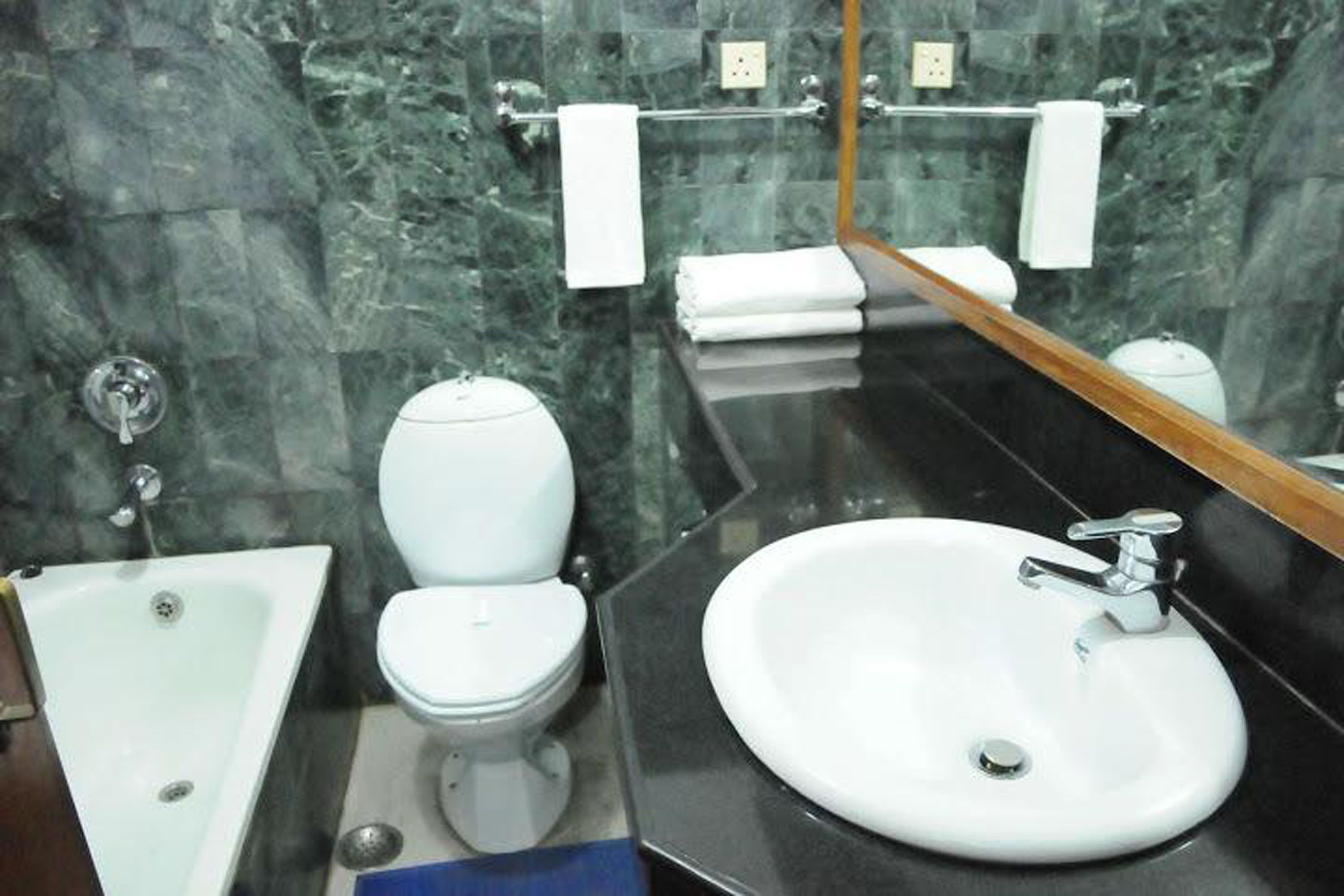 A bathroom with a white toilet, a white sink, and a bathtub.