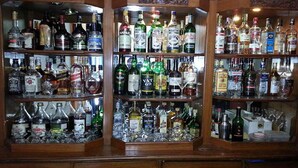 A bar with shelves stocked with various liquor bottles. - Hotel Clarion (Lalitpur)