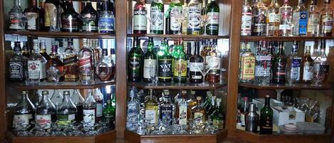 Un bar con estantes llenos de diferentes botellas de licores.